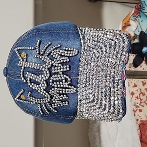 Distressed denim baseball cap with silver blinged studs on brim and crown